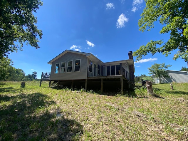 back of property featuring a wooden deck