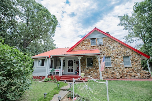 view of front of property with a porch and a front lawn