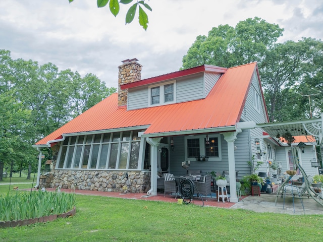 back of house with a patio, a sunroom, and a yard