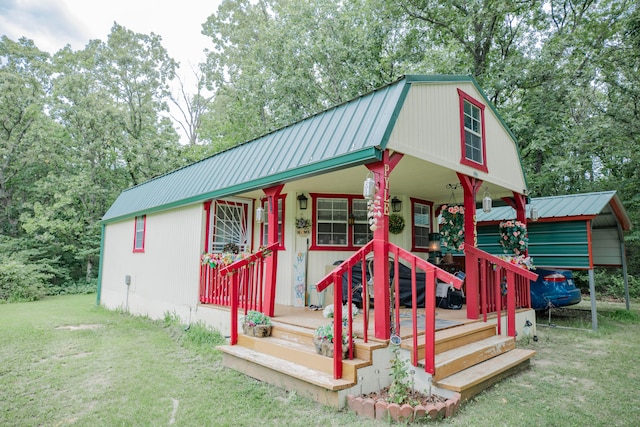 view of outbuilding featuring a porch and a yard