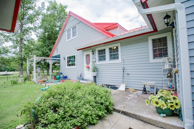 exterior space with a patio, a pergola, and a front yard