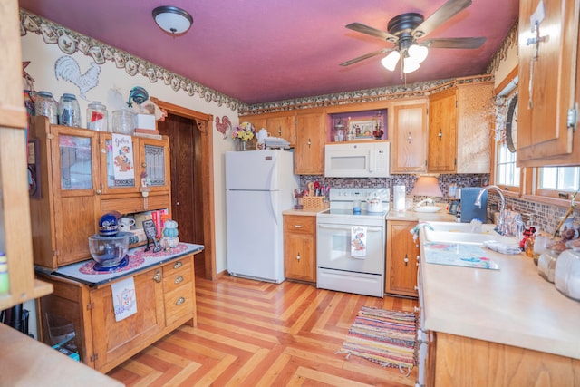 kitchen featuring sink, tasteful backsplash, ceiling fan, white appliances, and light parquet floors