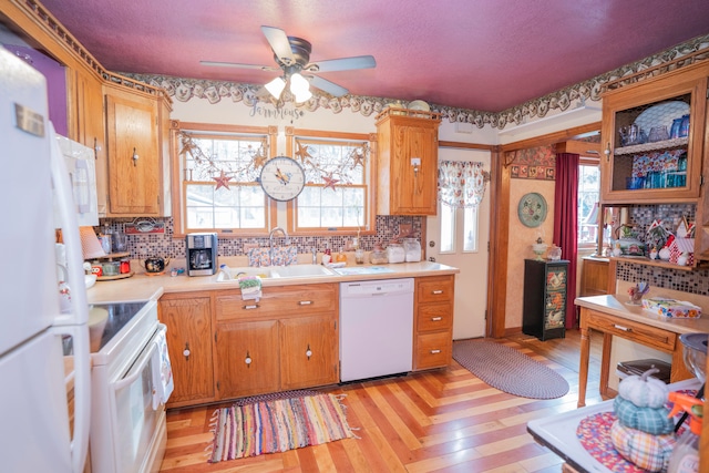 kitchen featuring white appliances, ceiling fan, a healthy amount of sunlight, and sink