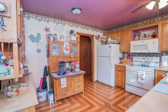 kitchen featuring light parquet flooring, decorative backsplash, ceiling fan, and white appliances