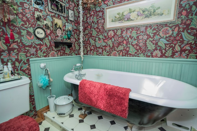 bathroom with a tub and toilet