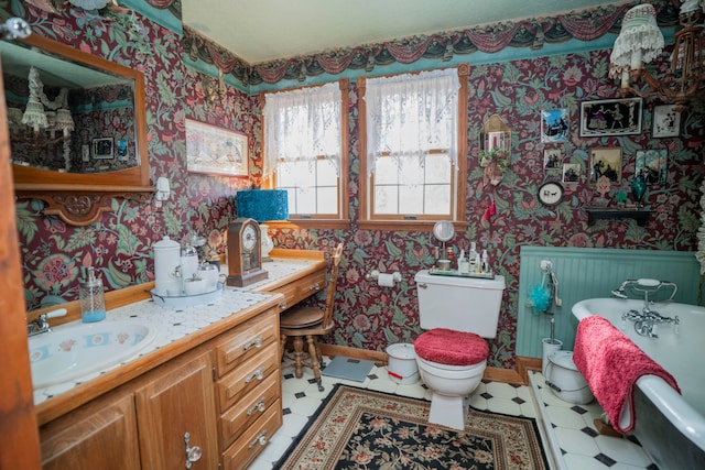 bathroom featuring toilet, vanity, and a bathing tub