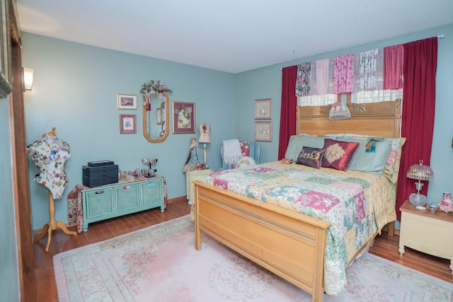 bedroom with hardwood / wood-style flooring