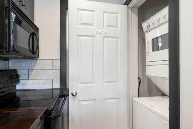 washroom featuring stacked washer / dryer