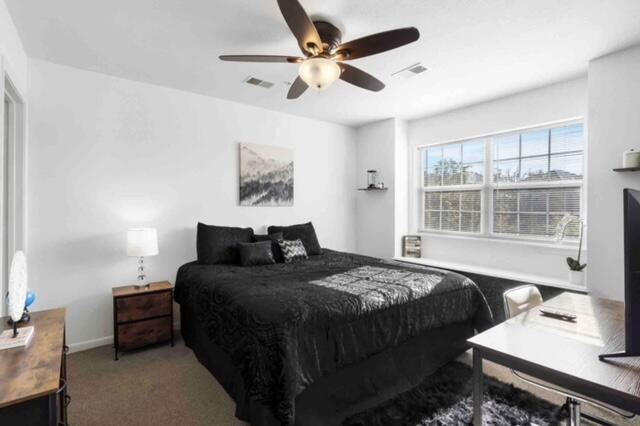 carpeted bedroom featuring ceiling fan