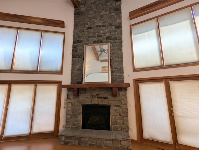 unfurnished living room featuring a stone fireplace