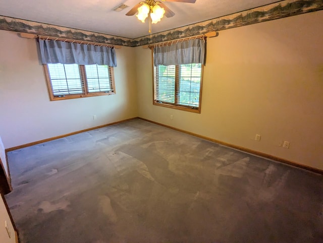 empty room featuring baseboards, visible vents, carpet, and ceiling fan