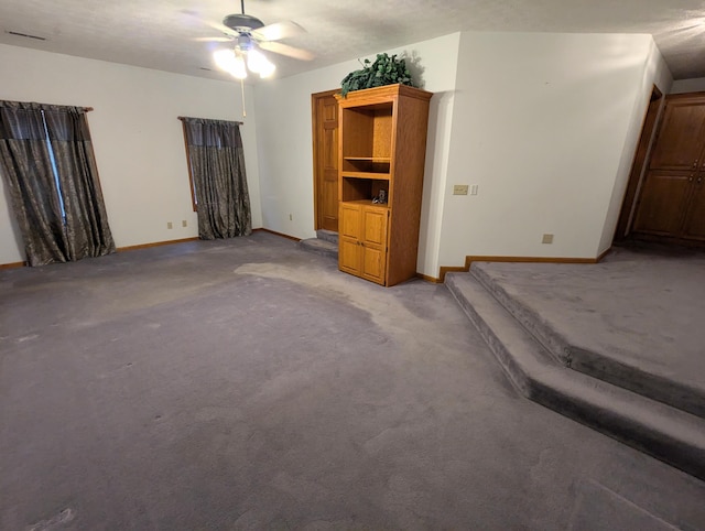 unfurnished bedroom featuring a ceiling fan, baseboards, and light colored carpet