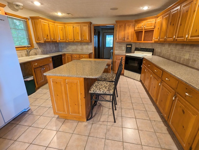 kitchen with a wealth of natural light, a sink, electric stove, and a kitchen island