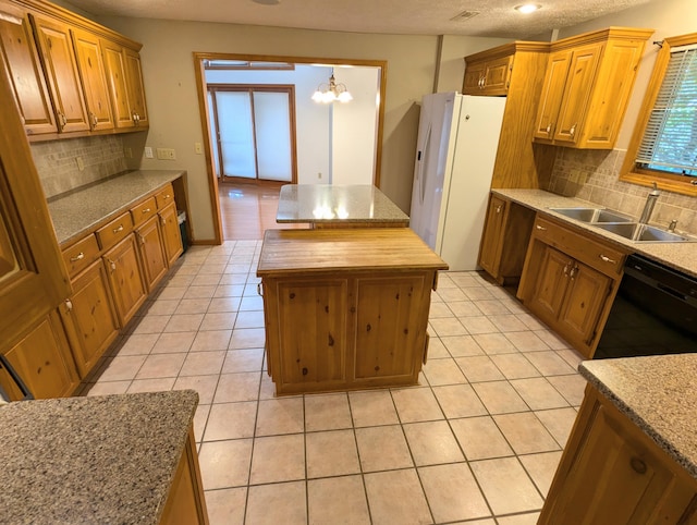 kitchen featuring sink, a chandelier, white fridge with ice dispenser, black dishwasher, and decorative backsplash