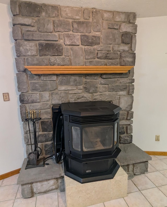 interior details with tile patterned floors and a wood stove