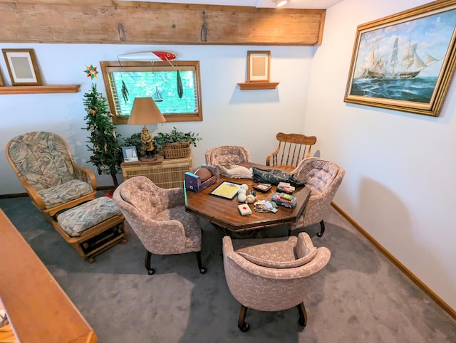 carpeted dining room featuring baseboards