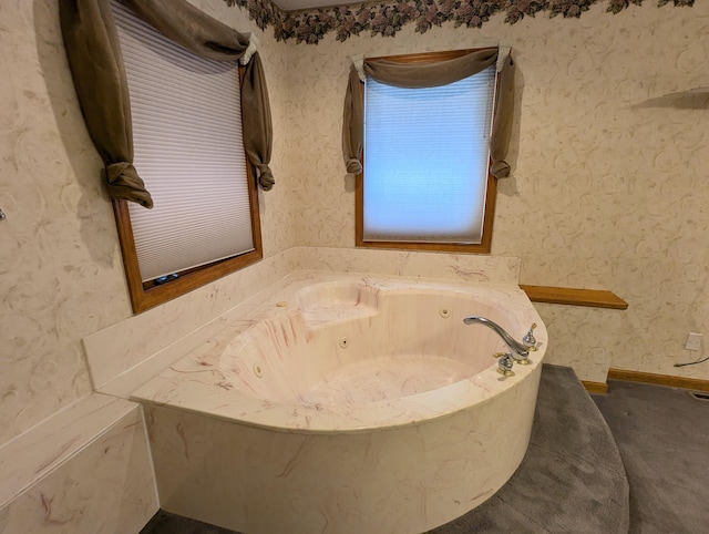 bathroom with a whirlpool tub and wallpapered walls