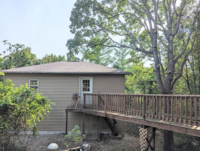 rear view of house featuring a wooden deck