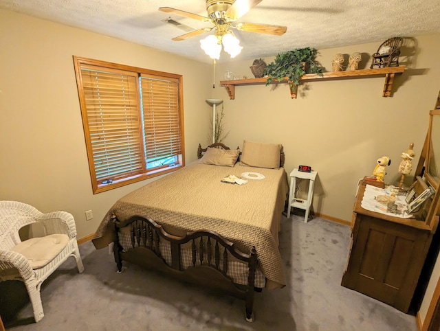 carpeted bedroom featuring ceiling fan and a textured ceiling