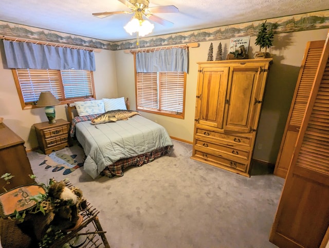 bedroom featuring carpet, a textured ceiling, and ceiling fan