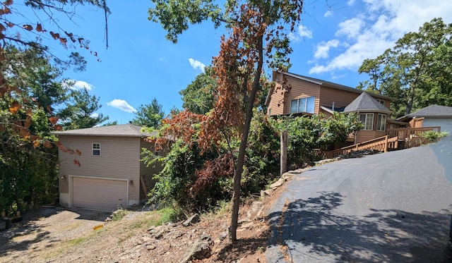 view of front of home with a garage and a wooden deck