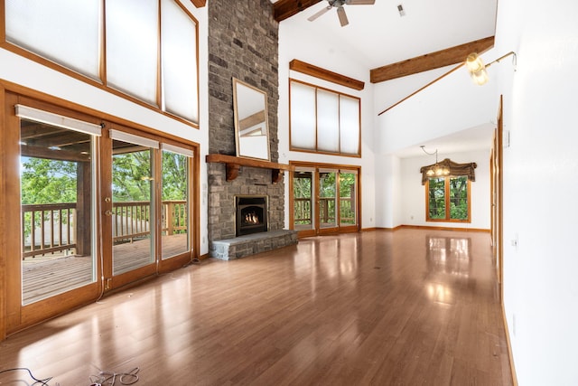 127 Kachina Trl, Branson West, MO 65737 - unfurnished living room featuring plenty of natural light, high vaulted ceiling, ceiling fan, wood finished floors, and beamed ceiling