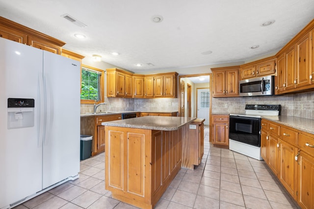 127 Kachina Trl, Branson West, MO 65737 - kitchen with white fridge with ice dispenser, stainless steel microwave, range with electric cooktop, a center island, and a sink