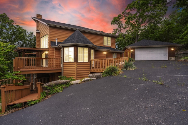 127 Kachina Trl, Branson West, MO 65737 - chalet / cabin with an outdoor structure, log veneer siding, a detached garage, a chimney, and a deck