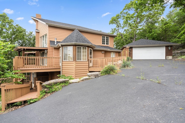 127 Kachina Trl, Branson West, MO 65737 - rustic home with an outdoor structure, a garage, a wooden deck, and roof with shingles