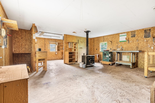 127 Kachina Trl, Branson West, MO 65737 - living area featuring a wood stove, plenty of natural light, and a workshop area
