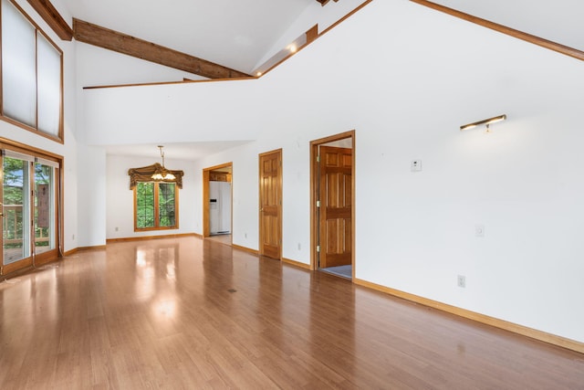 127 Kachina Trl, Branson West, MO 65737 - unfurnished living room featuring a chandelier, light wood finished floors, high vaulted ceiling, beam ceiling, and baseboards