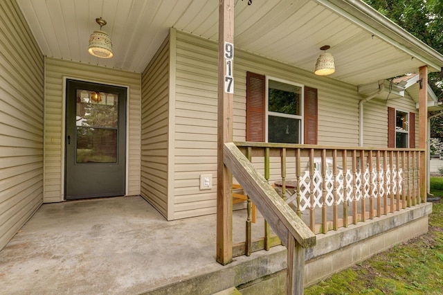 view of exterior entry with covered porch