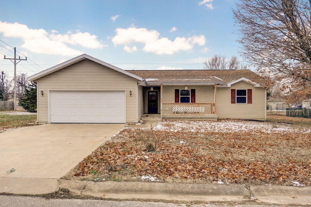 ranch-style house with covered porch and a garage