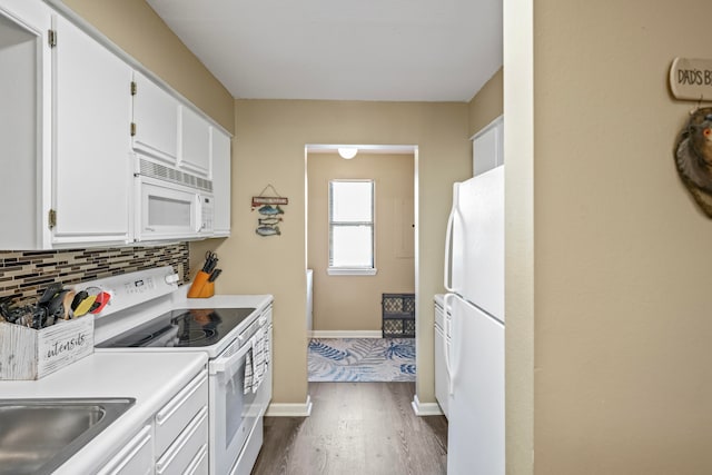 kitchen with white cabinets, backsplash, dark wood-type flooring, and white appliances