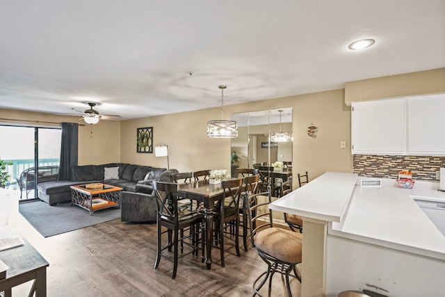 dining area with ceiling fan and dark hardwood / wood-style flooring