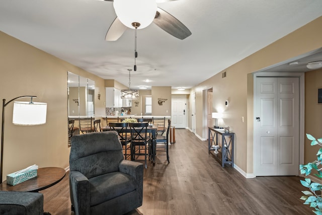 living room featuring hardwood / wood-style flooring and ceiling fan