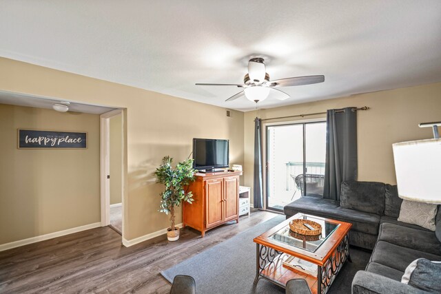 living room with hardwood / wood-style floors and ceiling fan