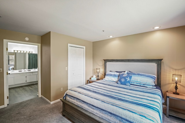 bedroom with carpet floors, a closet, and ensuite bathroom