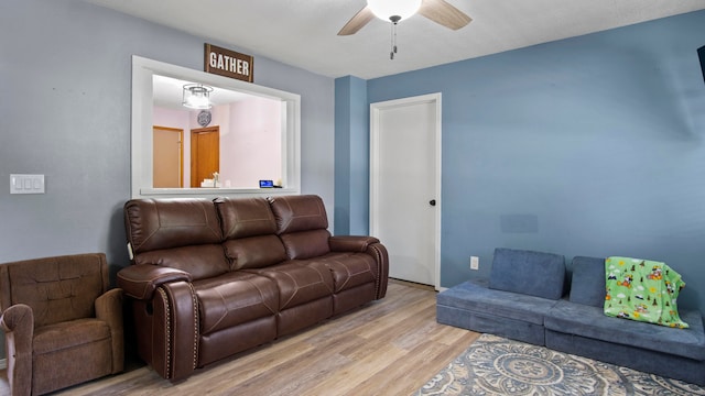 living room with ceiling fan and light wood-type flooring