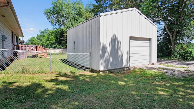 view of outdoor structure featuring a yard and a garage