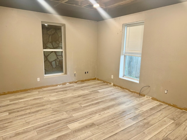 spare room featuring light wood finished floors