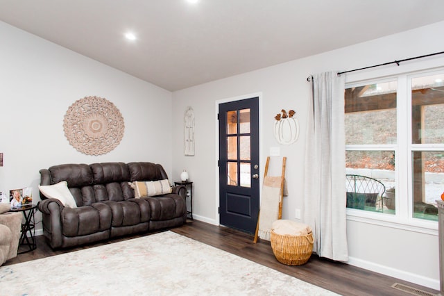 living area with recessed lighting, visible vents, baseboards, and dark wood-style floors
