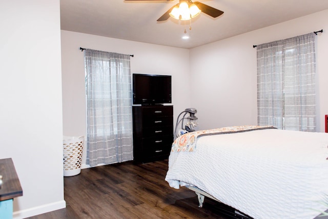 bedroom featuring wood finished floors, a ceiling fan, and baseboards