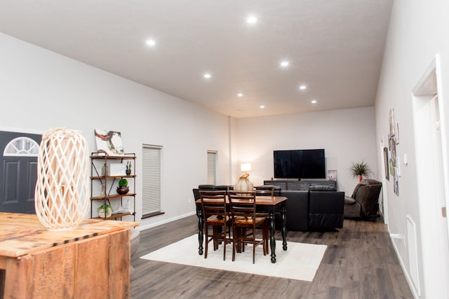 dining area with baseboards, wood finished floors, and recessed lighting