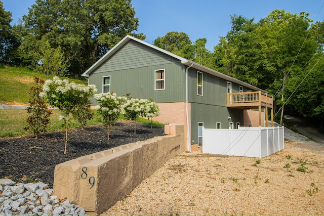 back of house with a wooden deck and fence