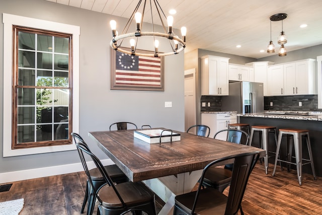 dining area with a notable chandelier, wood ceiling, and dark hardwood / wood-style flooring