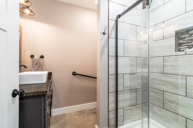 bathroom with vanity and a shower with door