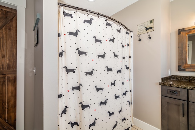 bathroom featuring vanity and curtained shower