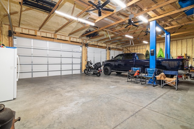 garage with white fridge and ceiling fan