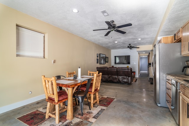 dining room with ceiling fan and a textured ceiling